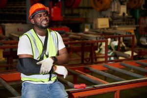 Injured factory worker wearing bandages and splint from hard work in the factory